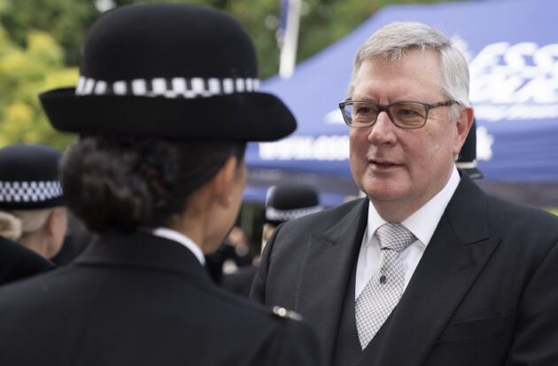 Roger Hirst speaking to officer at pass out parade.