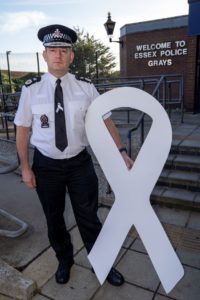Phpto of Essex Police's Chief Constable Ben Julian Harrington with the giant white ribbon