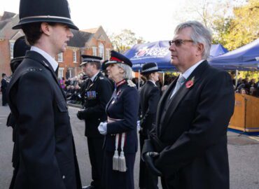 Roger Hirst is talking to the new officers at the passout parade. There are four people in the photo and they are stood outside police headquarters.