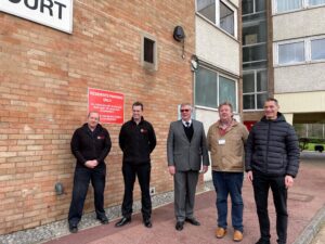 Mark Earwicker and Chris Parker from Essex County Fire and Rescue Service, PFCC Roger Hirst, Cllr Ian Gilbert and Paul Longman from South Essex Homes outside Cecil Court in Southend.